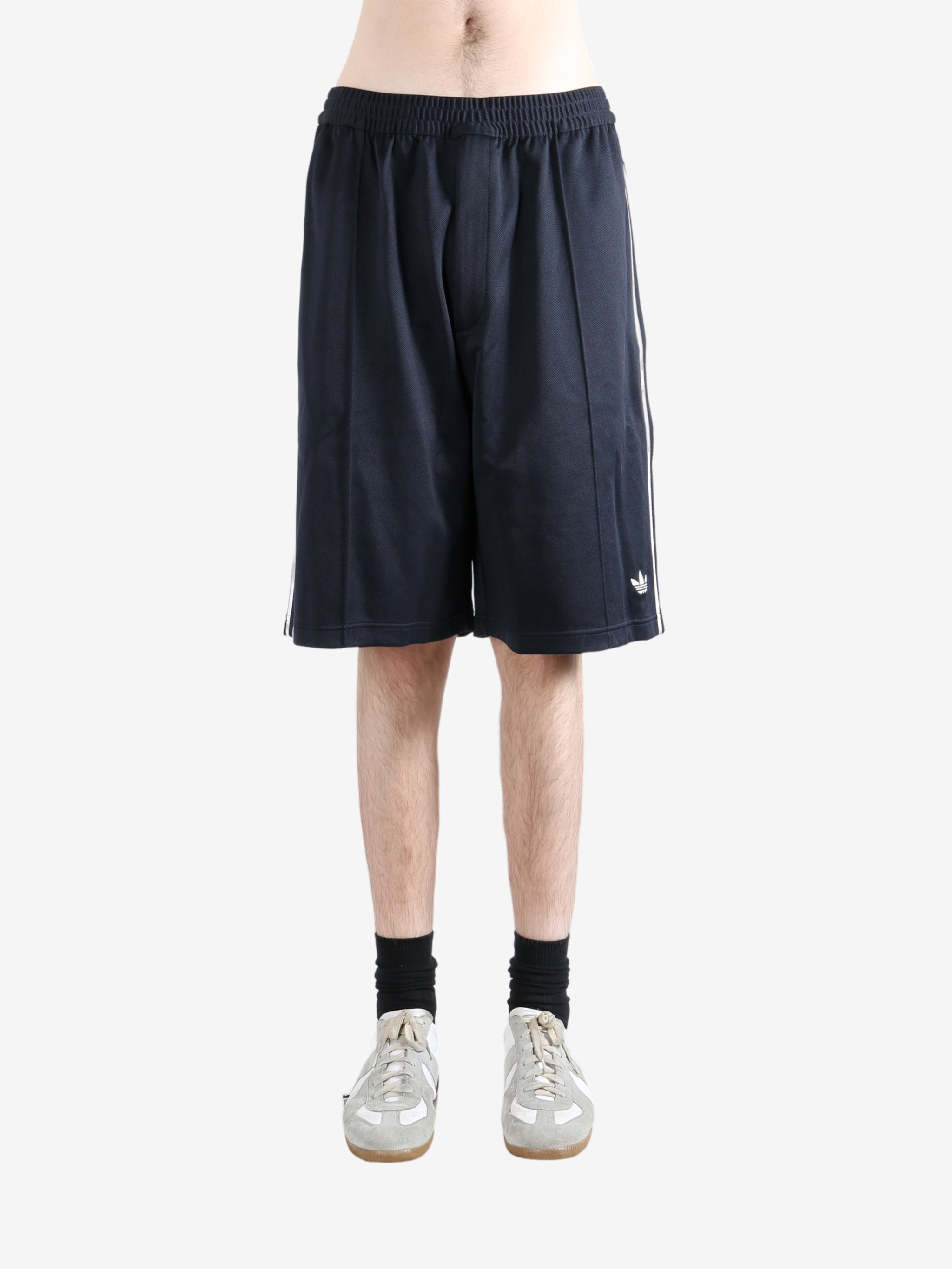 Navy shorts worn by a person, showing the shorts fit