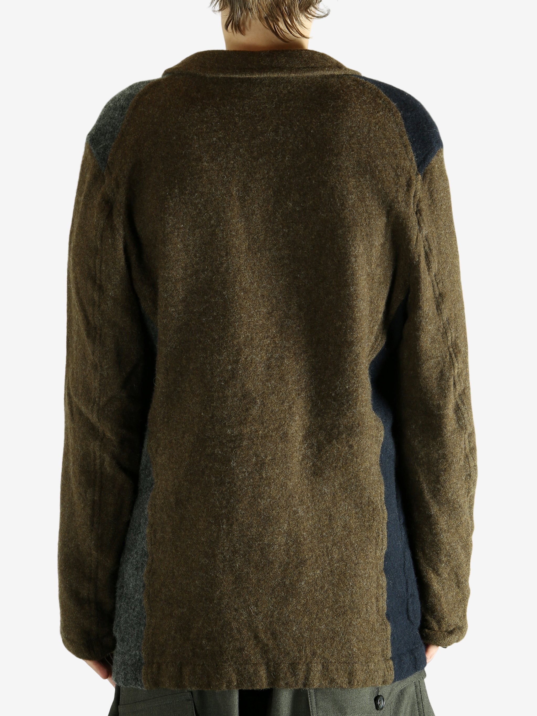 Brown jacket worn by a person. showing the jacket's fit