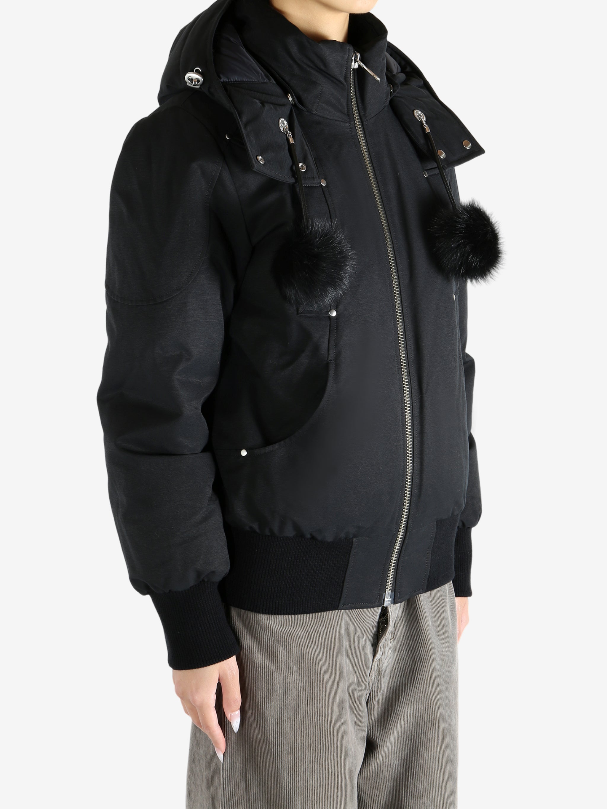 Black coat worn by a person, showing the coat fit