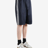 Navy shorts worn by a person, showing the shorts fit