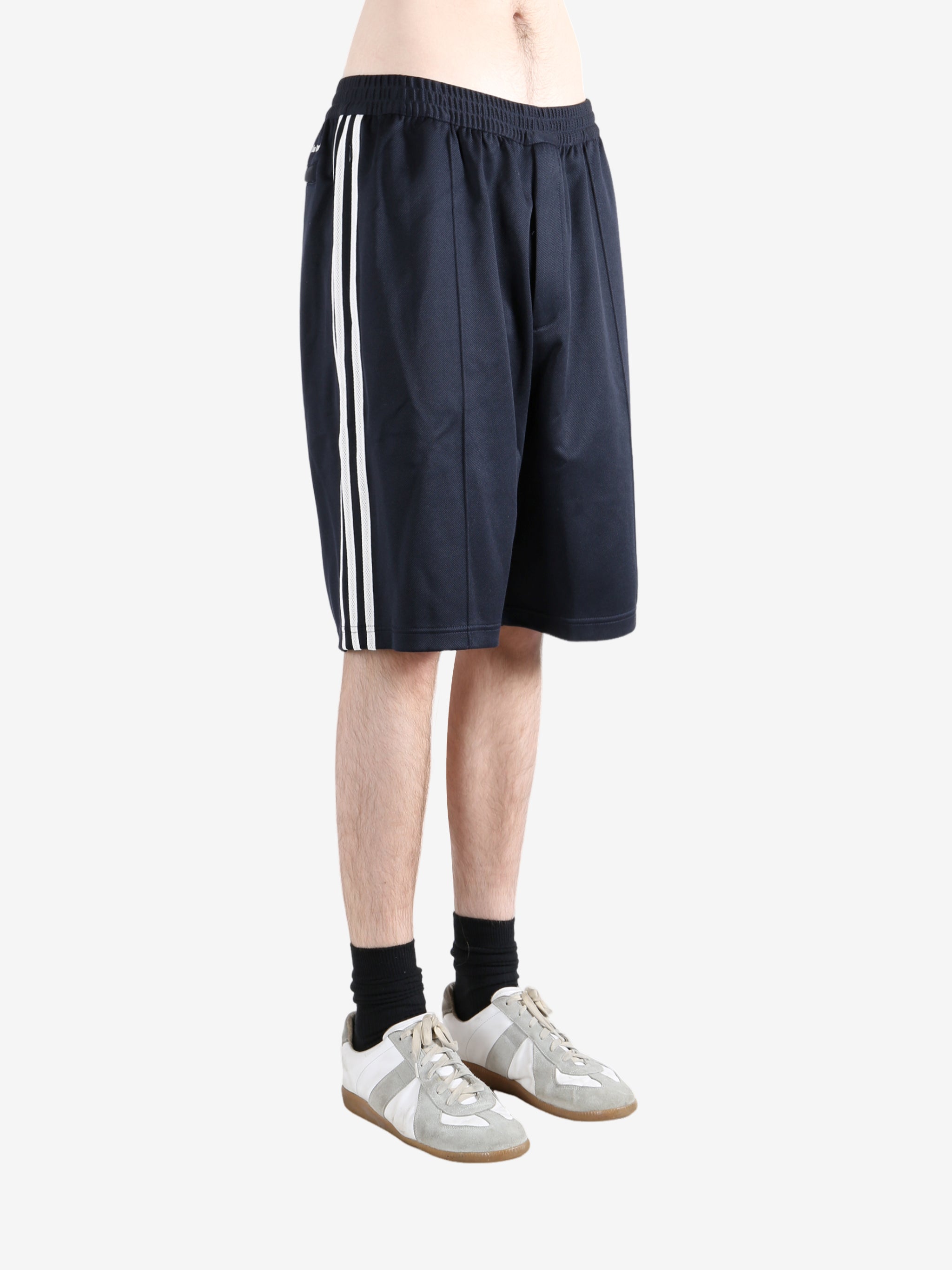 Navy shorts worn by a person, showing the shorts fit