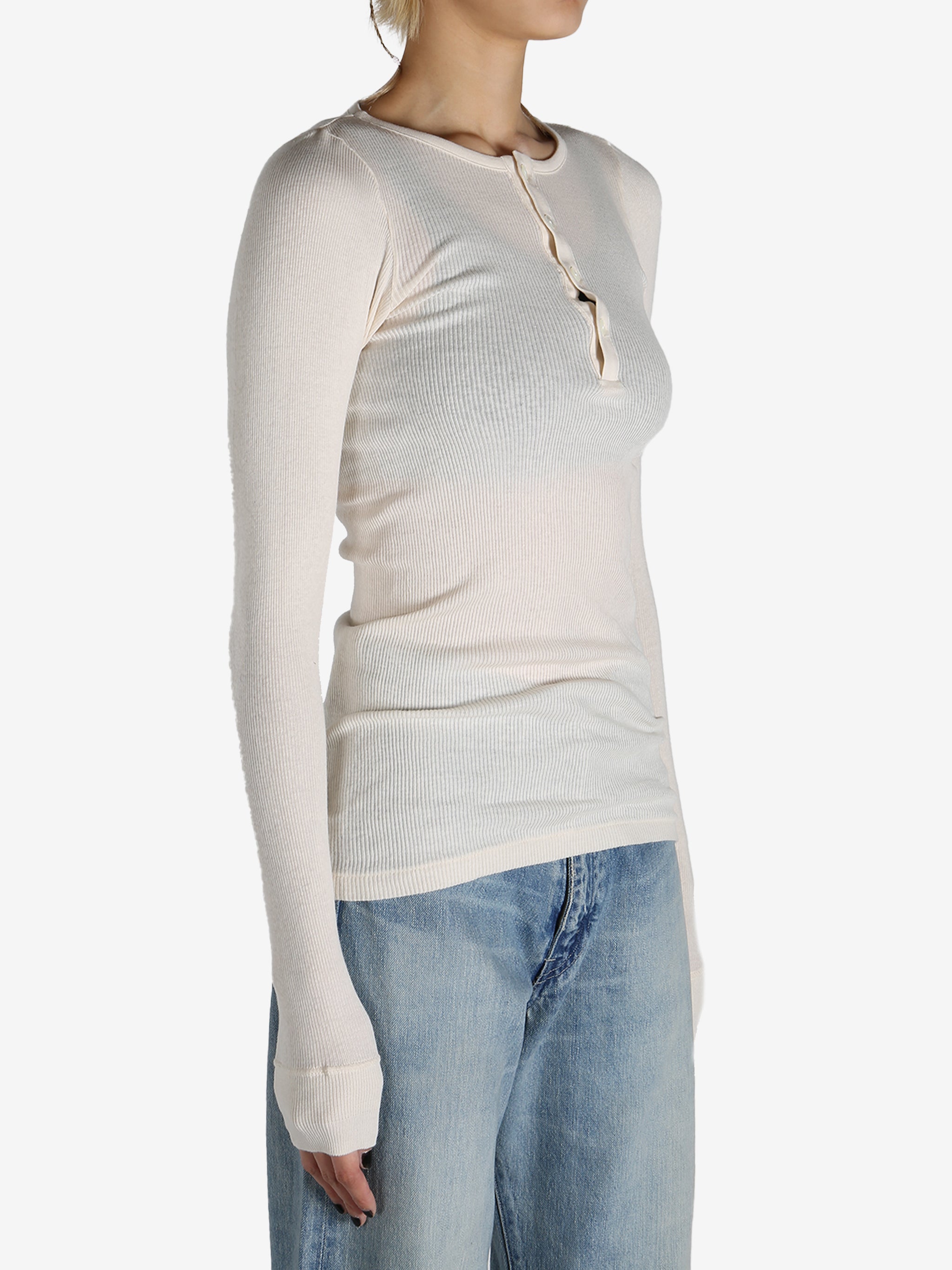 White T-shirt worn by a person, showing the shirt's fit
