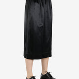 black skirt worn by a person, showing the skirt fit
