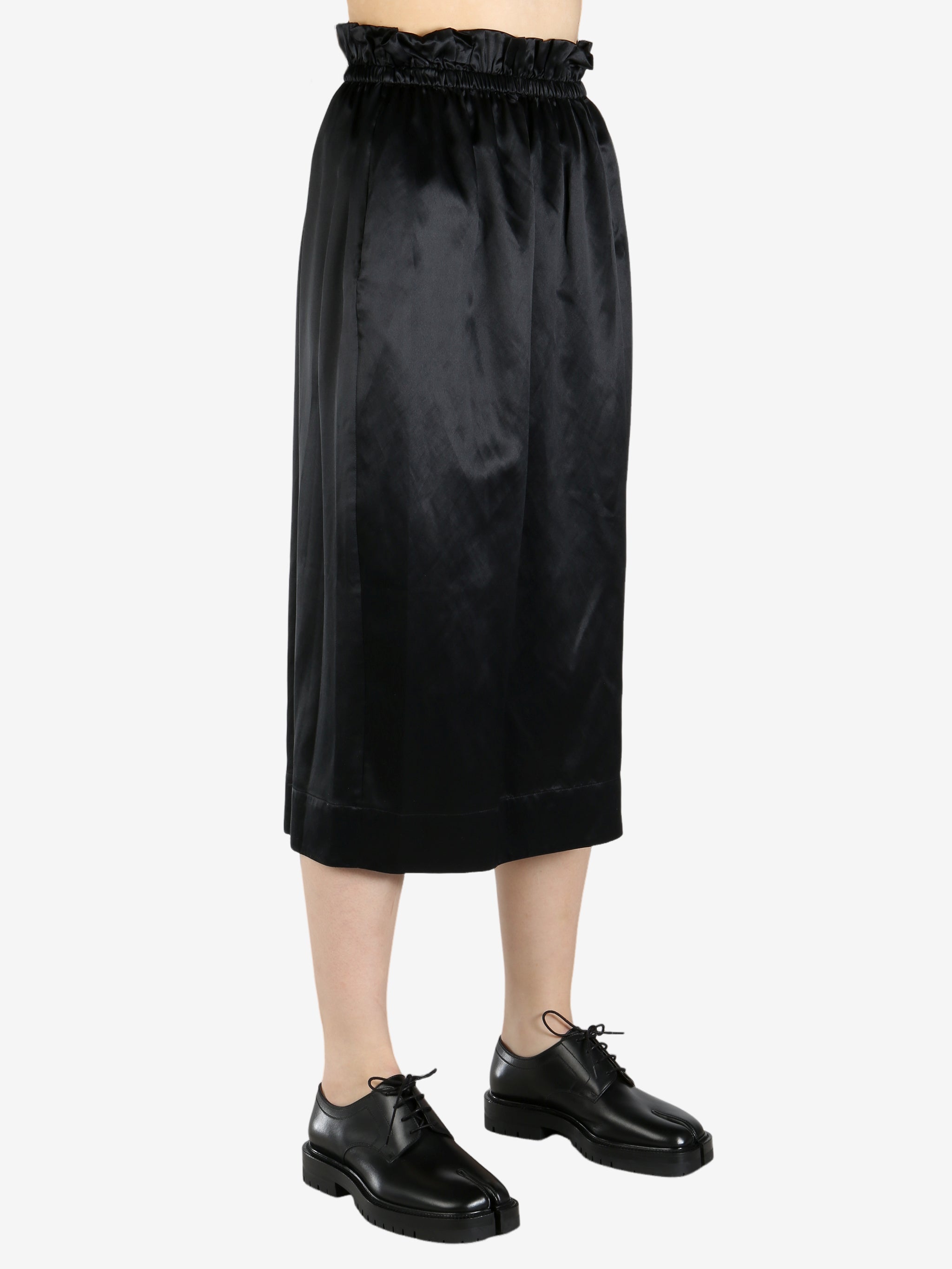black skirt worn by a person, showing the skirt fit
