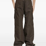 Brown pants worn by a person, showing the pants fit