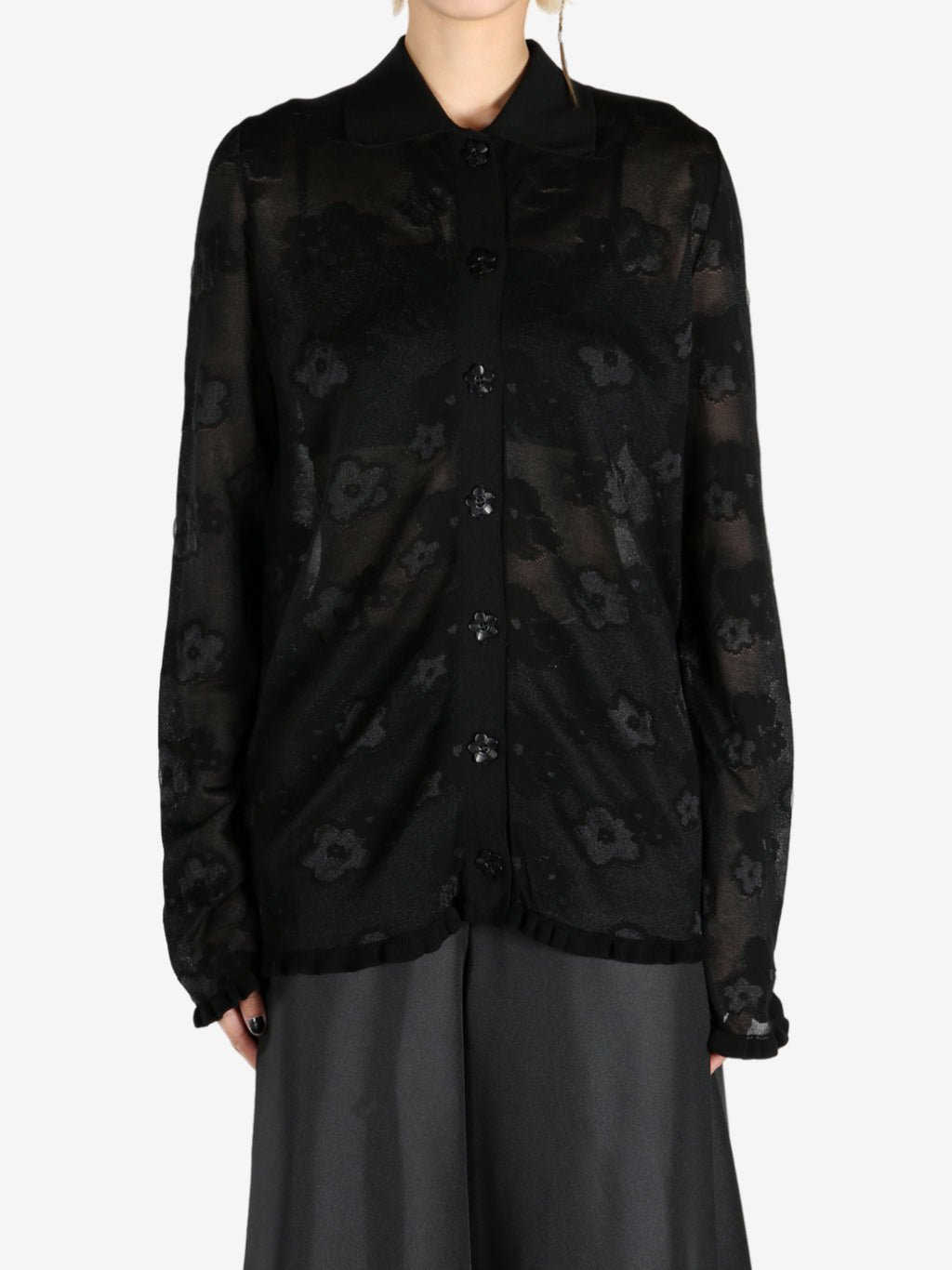 Black cardigan worn by a person, showing the cardigan's fit
