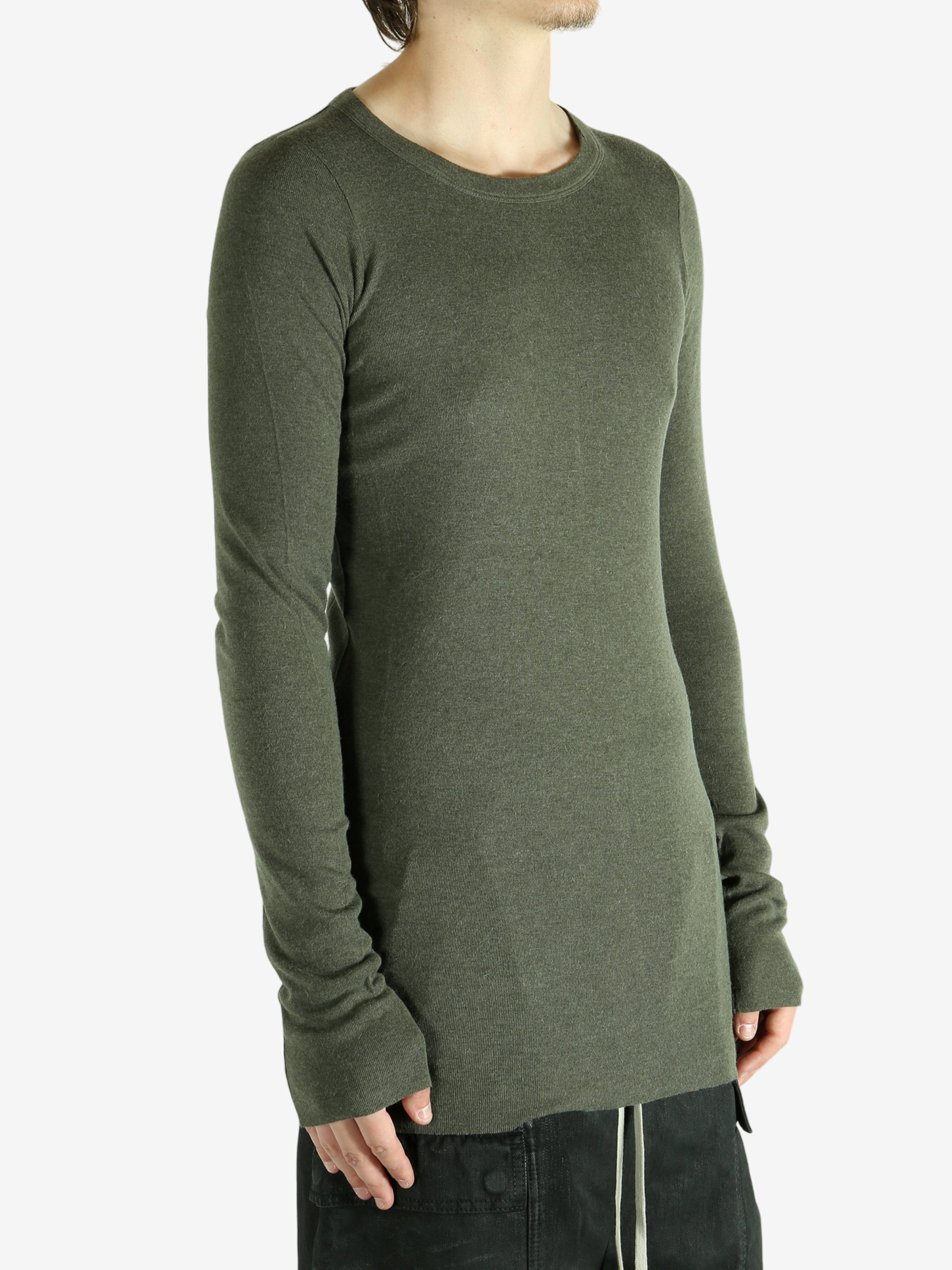 Green t-shirt worn by a person, showing the shirt's fit