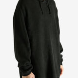 Black hoodie worn by a person, showing the hoodie's fit