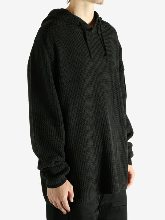 Black hoodie worn by a person, showing the hoodie's fit