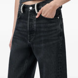 Black jeans worn by a person, showing the jeans fit
