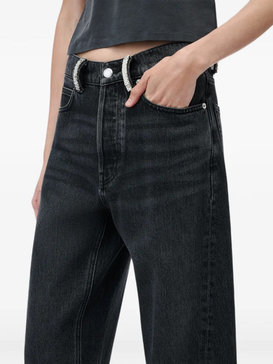 Black jeans worn by a person, showing the jeans fit