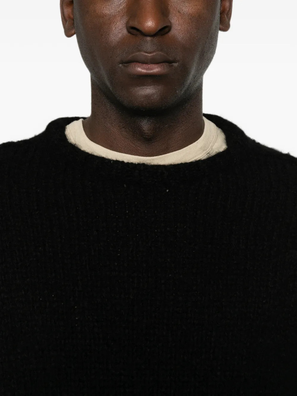 Black knitwear worn by a person, showing the knitwear fit
