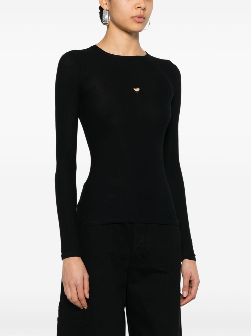 Black T-shirt worn by a person, showing the shirt’s fit