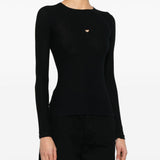 Black T-shirt worn by a person, showing the shirt’s fit