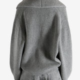  gray sweater  worn by a person, showing the sweater fit
