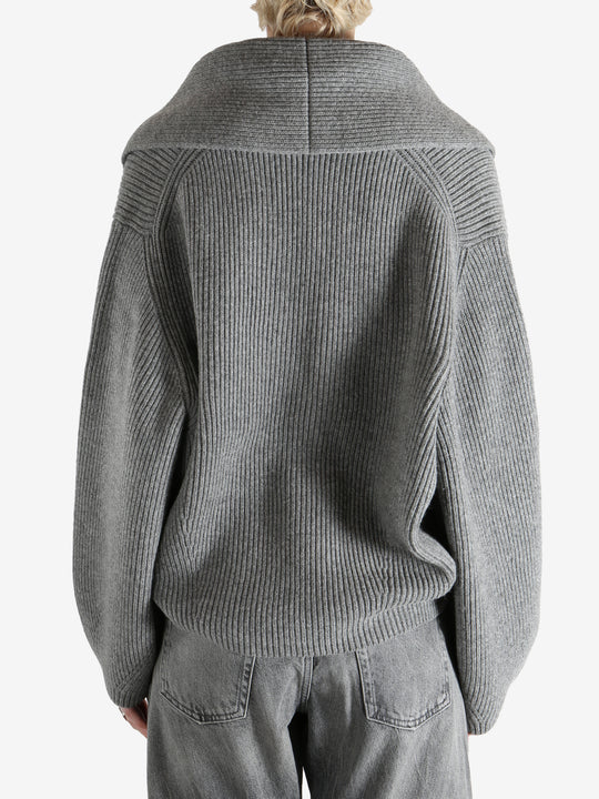  gray sweater  worn by a person, showing the sweater fit