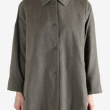 Grey coat worn by a person, showing the coat fit