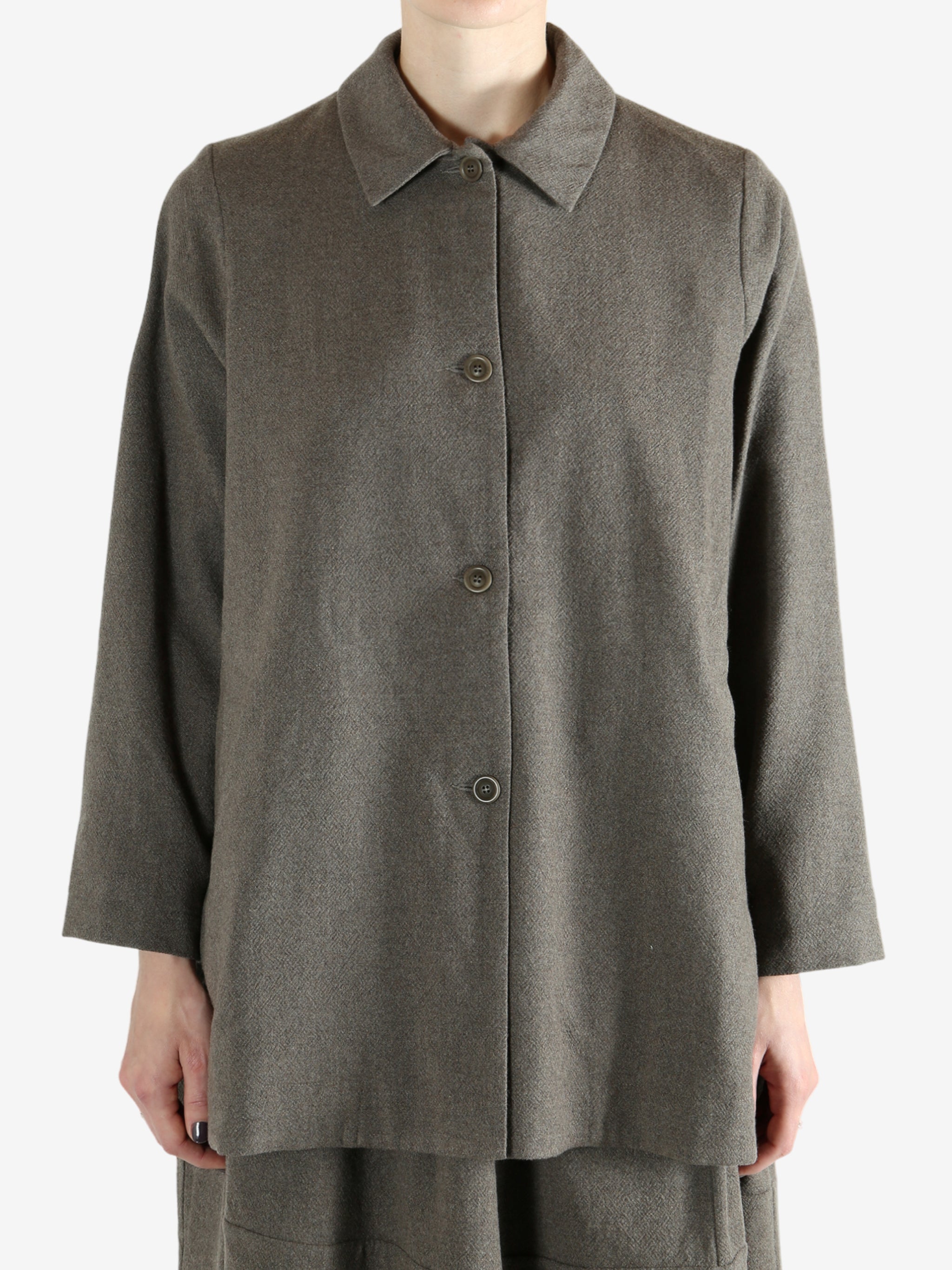 Grey coat worn by a person, showing the coat fit