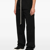 Black pants worn by a person, showing the pants's fit