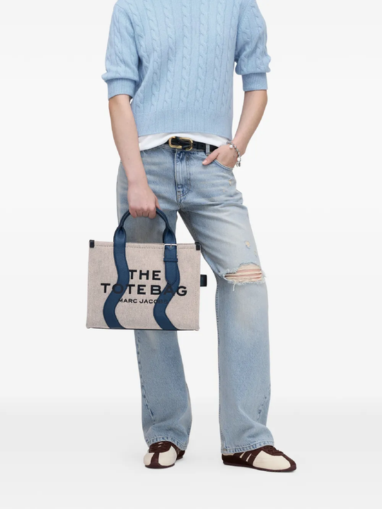 Navy bag,worn by a person, showing the bag fit