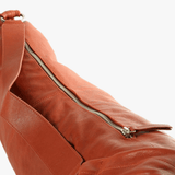 Close up of brown bags, showing texture of the leather fabric