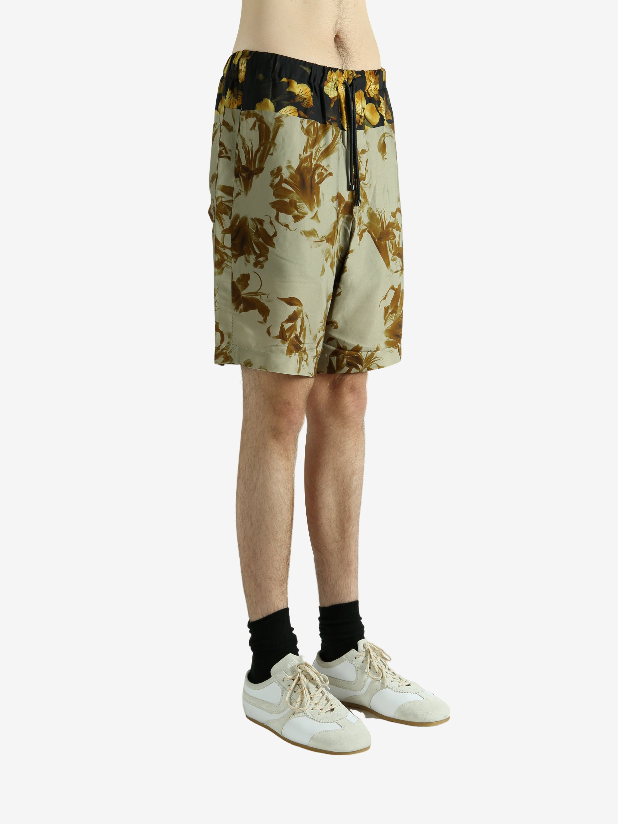 Green pants worn by a person, showing the pants' fit