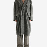 Grey coat worn by a person, showing the coat's fit