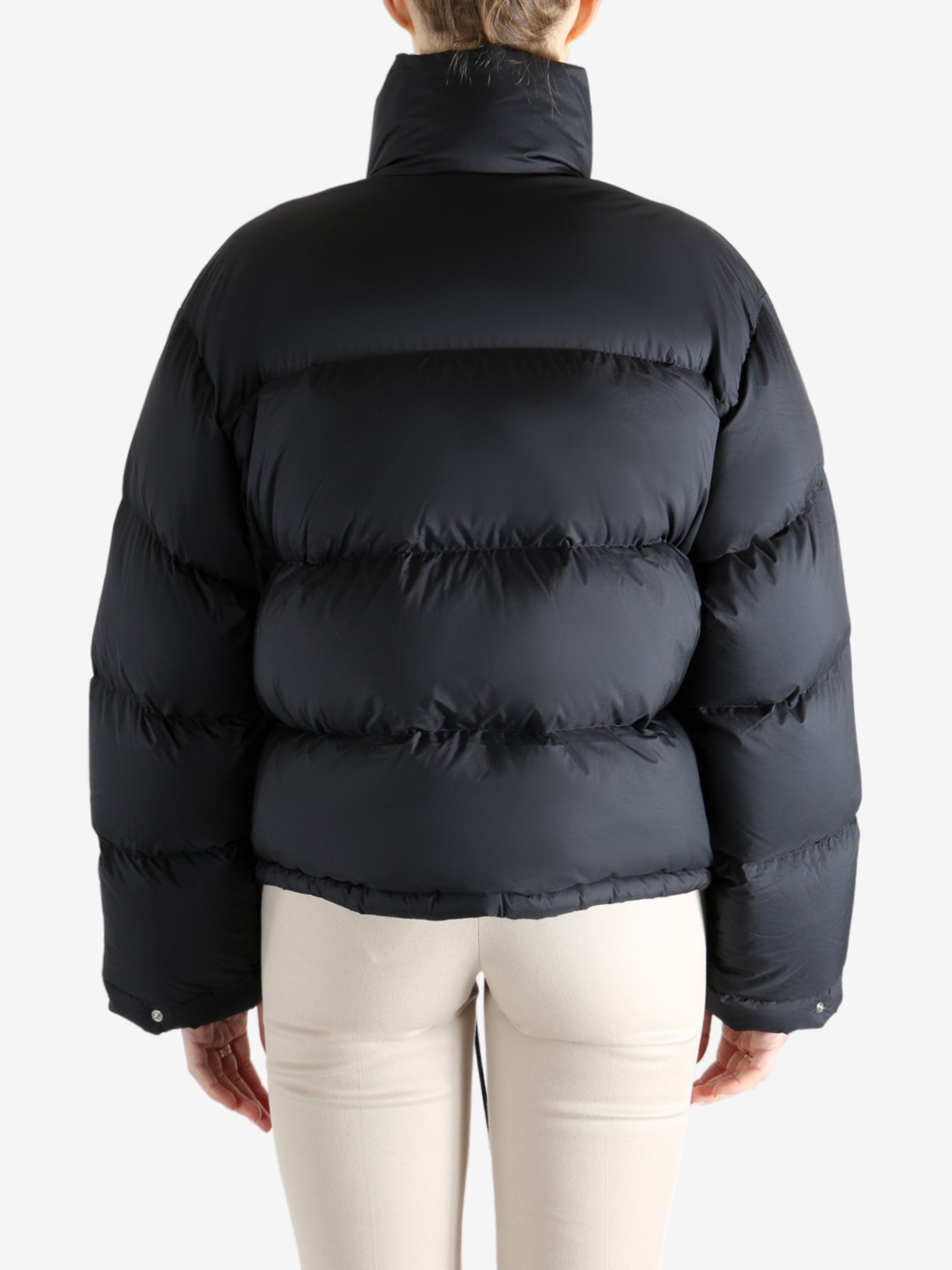 Black jacket worn by a person, showing the jacket fit