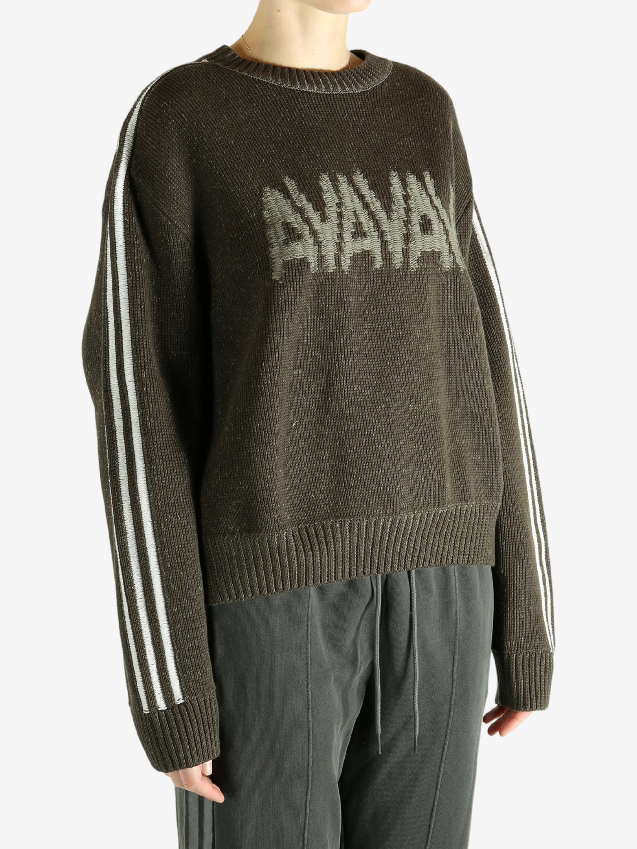 Brown sweater worn by a person, showing the sweater's  fit