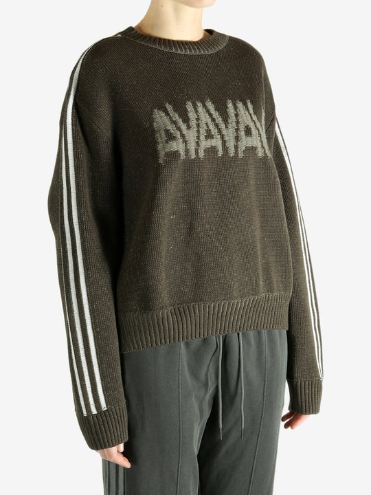 Brown sweater worn by a person, showing the sweater's  fit