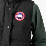 Close up of black vest, showing texture of the cotton fabric