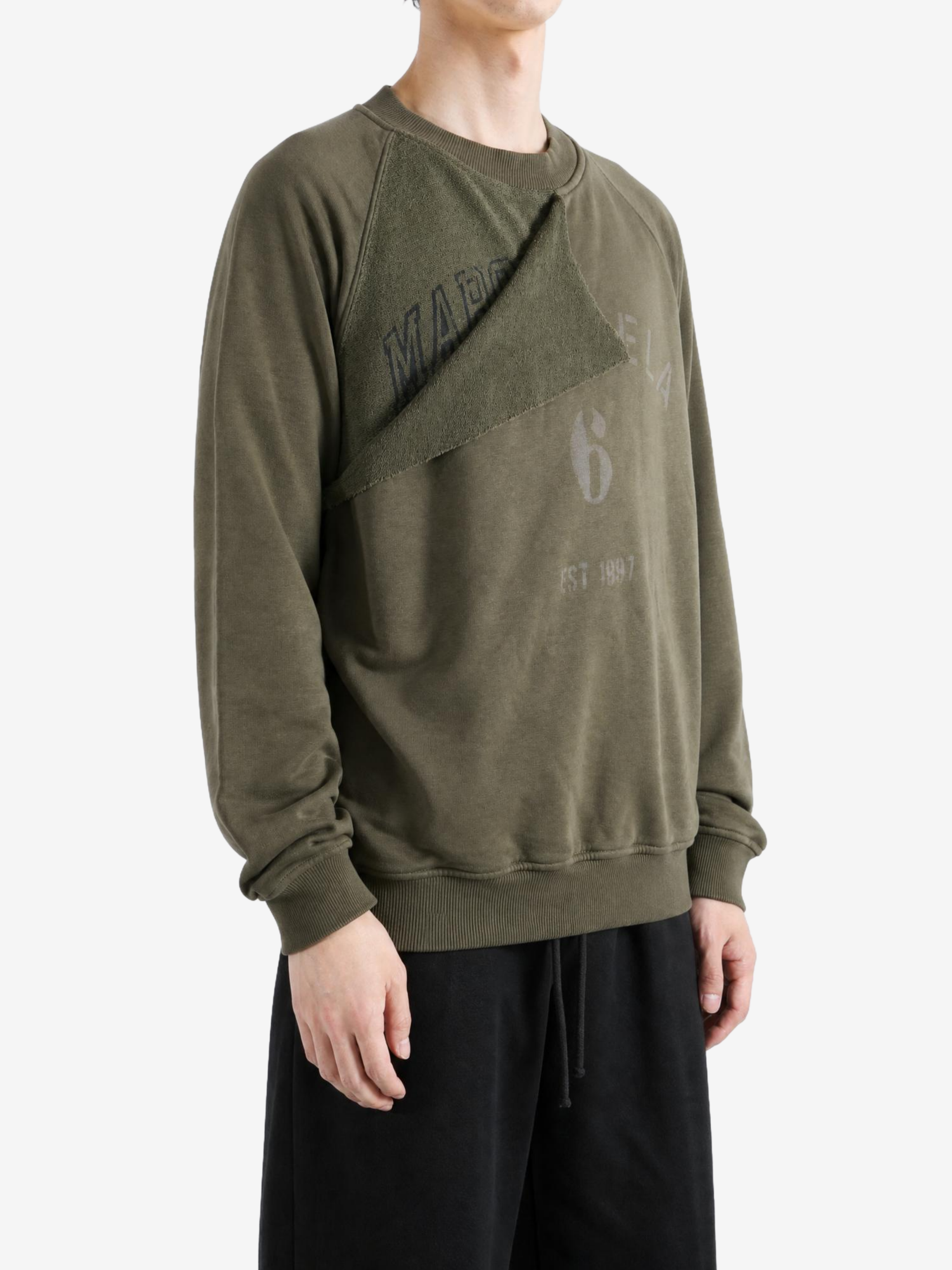 Green hoodie worn by a person, showing the hoodie fit