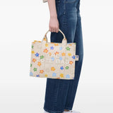 Tan bag carried by a person, showing the bag’s style