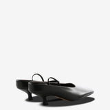 Black mules, back view