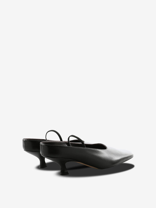 Black mules, back view