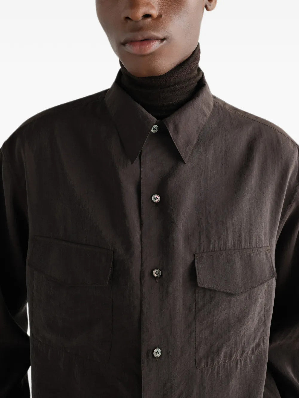 Brown shirt worn by a person, showing the shirt fit