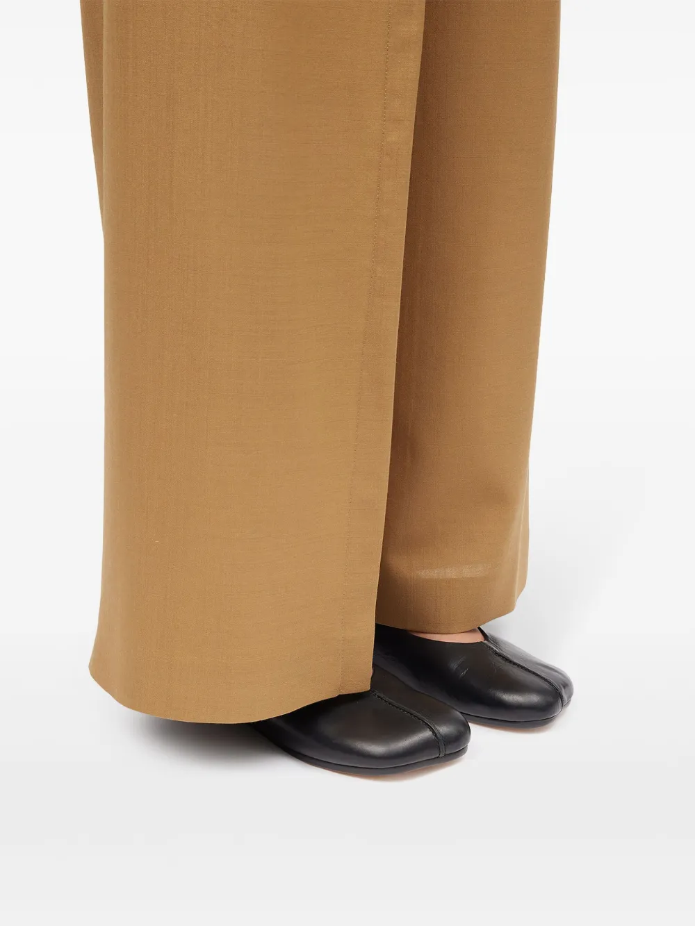 Black shoes worn by a person, showing the shoes fit