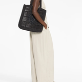 Black bag worn by a person, showing the bag's fit