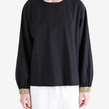 Black top worn by a person, showing the top fit