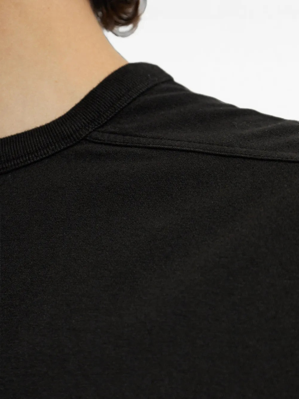 Black t-shirt worn by a person, showing the t-shirt fit