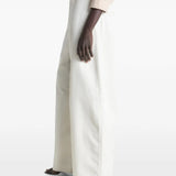 White pants worn by a person, showing the pants fit