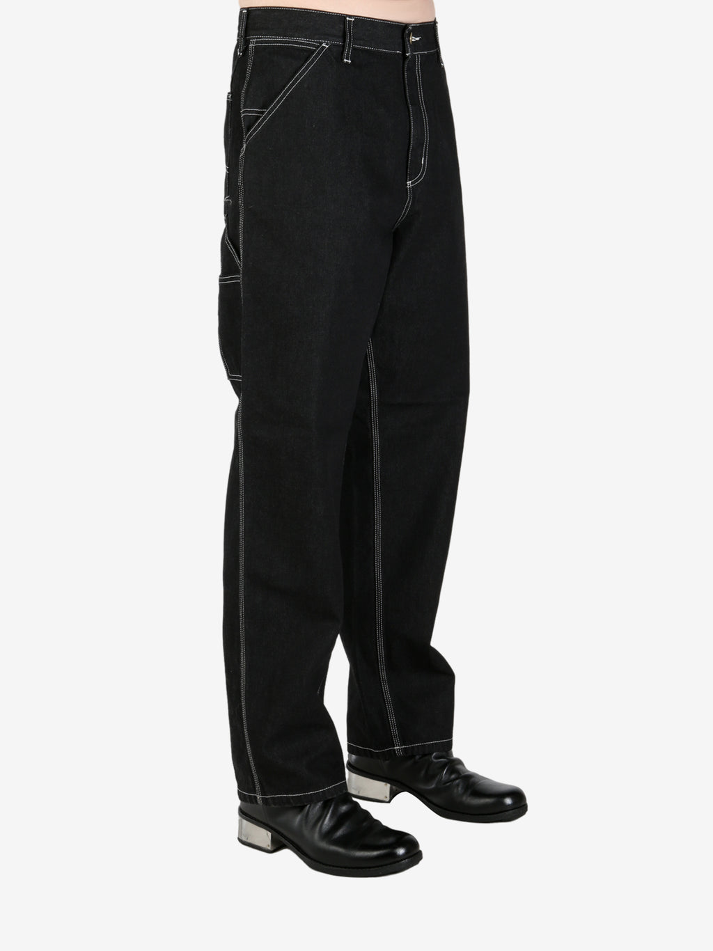 Black pants worn by a person, showing the pant's fit