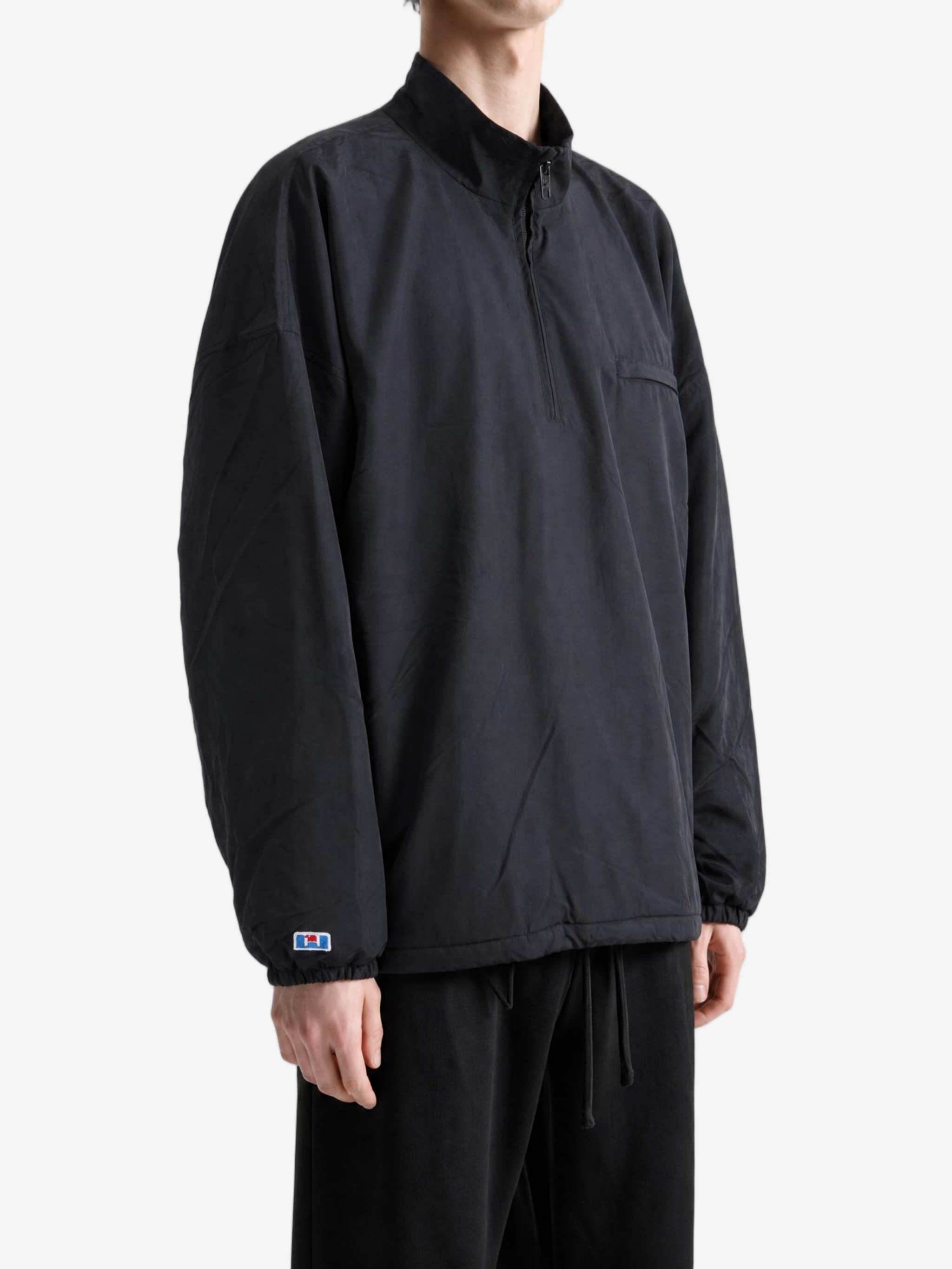 Black jacket worn by a person, showing the jacket fit