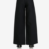 Black pants worn by a person, showing the pants's fit