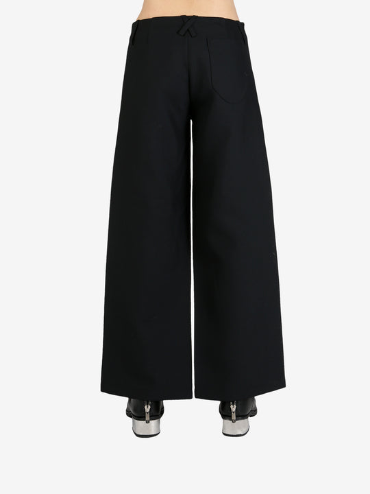 Black pants worn by a person, showing the pants's fit