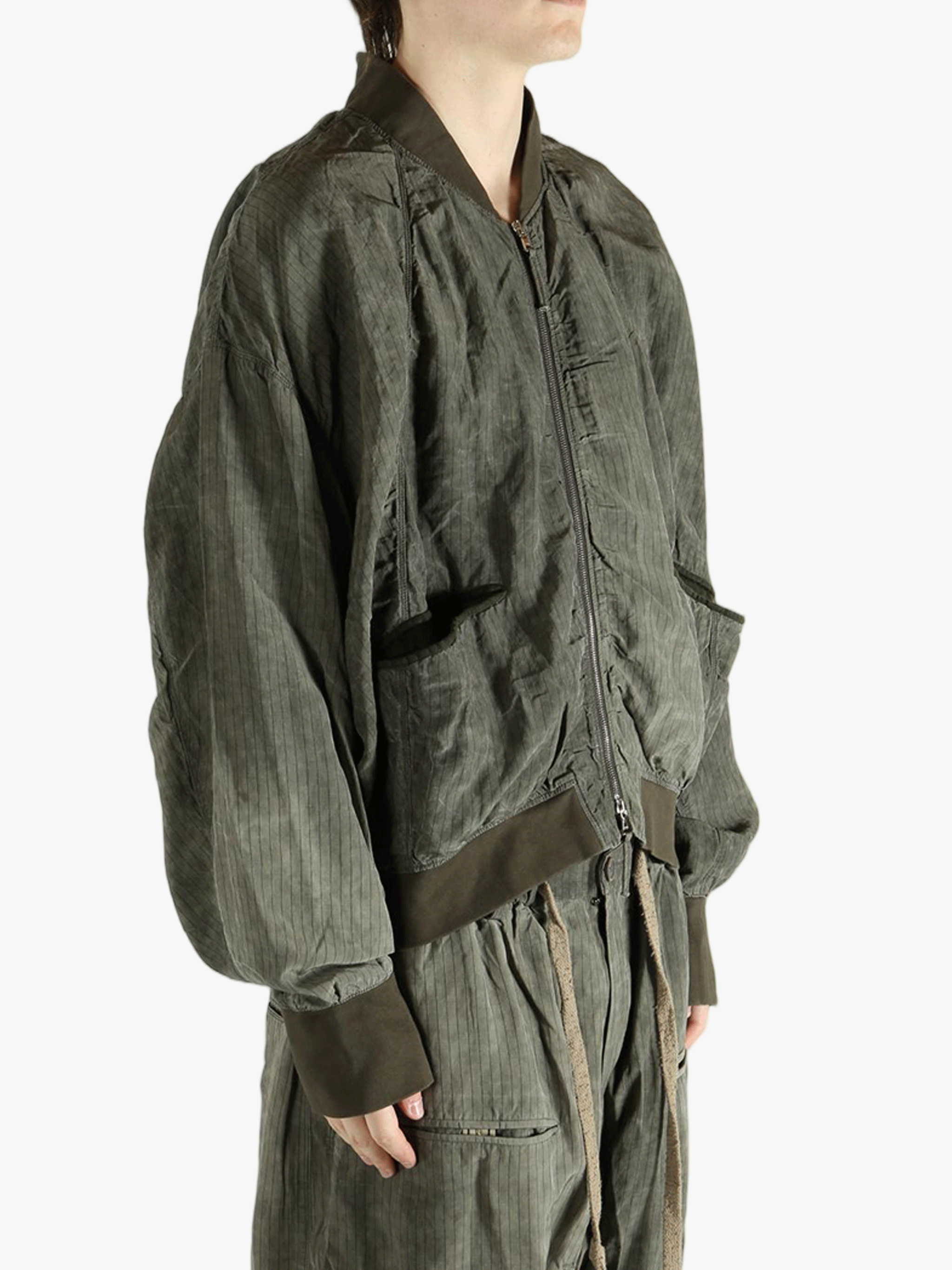 Green jackets worn by a person, showing the jackets fit