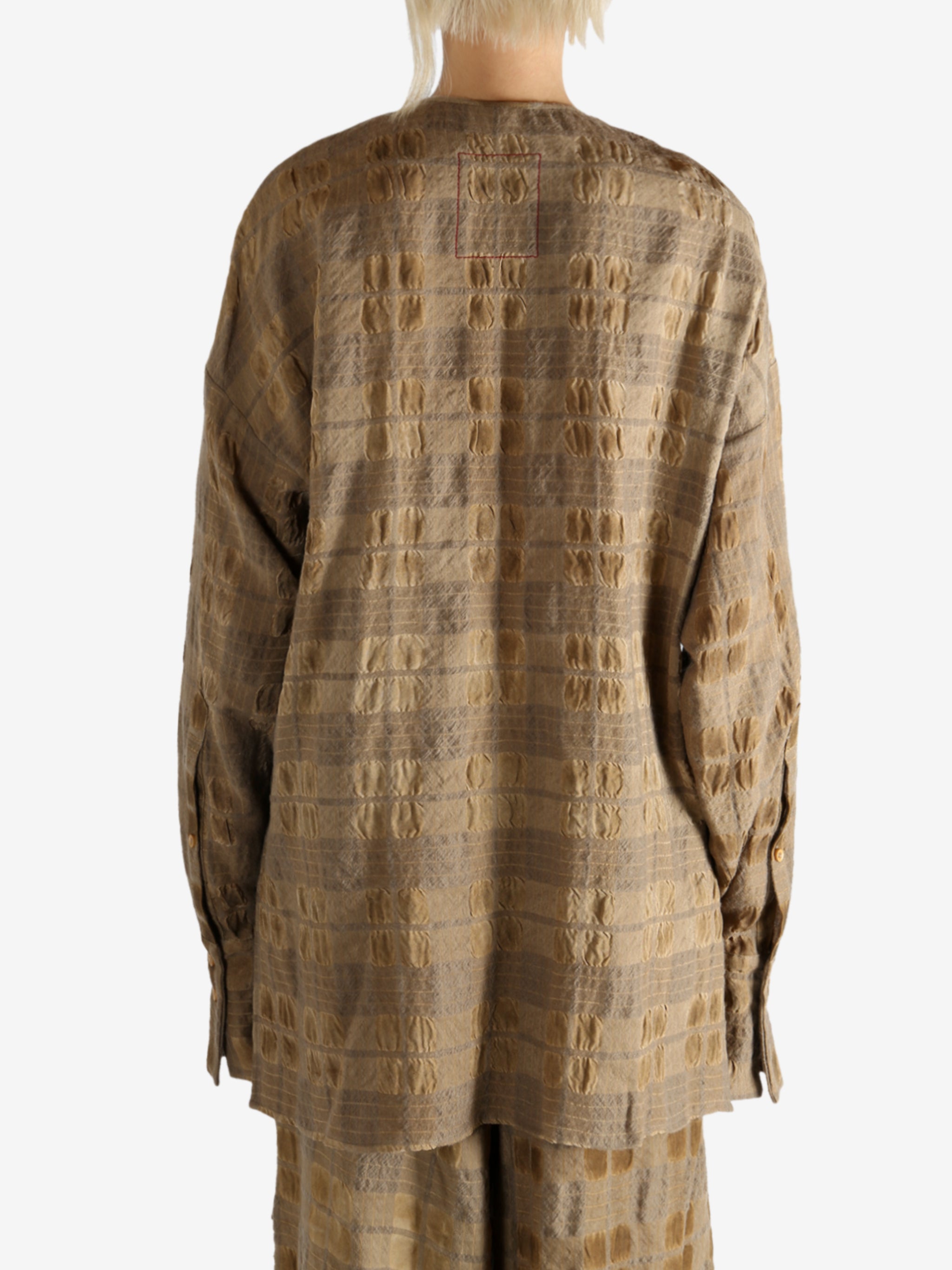 Brown top worn by a person, showing the top fit