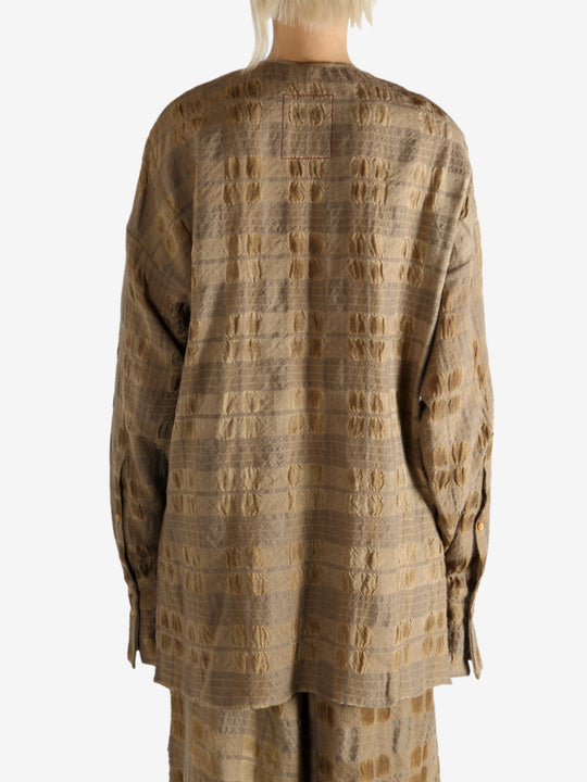 Brown top worn by a person, showing the top fit