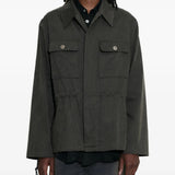 Green jacket worn by a person, showing the jacket's fit