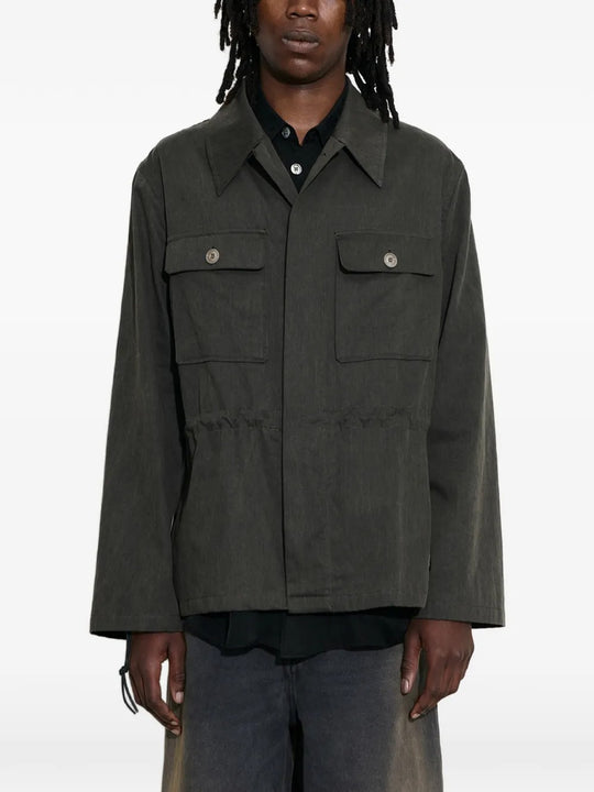 Green jacket worn by a person, showing the jacket's fit
